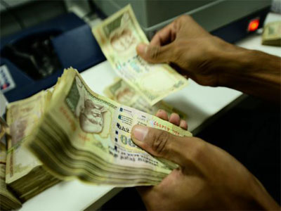 Rupee erases losses, trades higher at 65.05 per US dollar